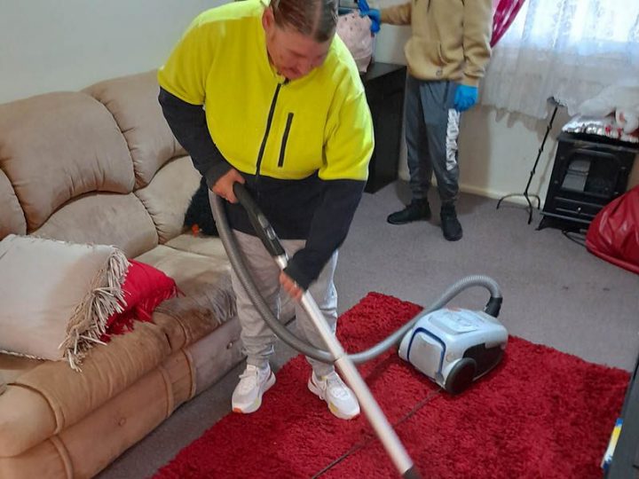 Amanda vacuuming the rug.